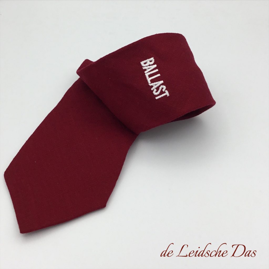 Made to order personalised ties woven in a solid color with brand name, custom ties