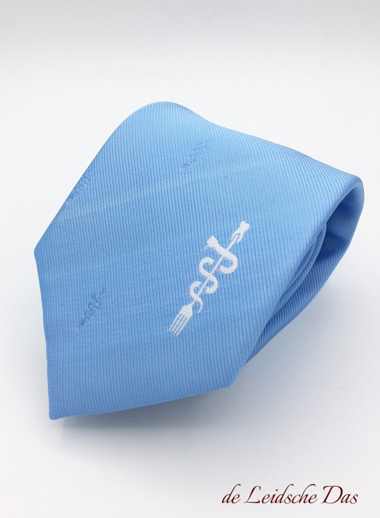 Light blue custom logo ties - Personalized institutional ties custom woven (repp tie) in light blue with a main logo and recurring logos.
